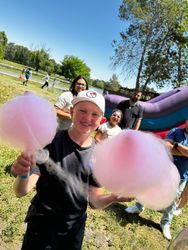 Student holding cotton candy at an outdoor school carnival