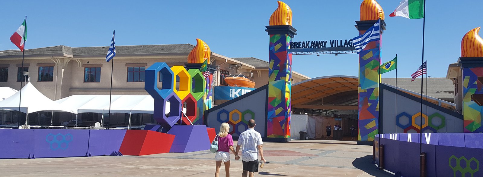 Breakaway Village entrance with inflatable torches and international flags built by Custom Events
