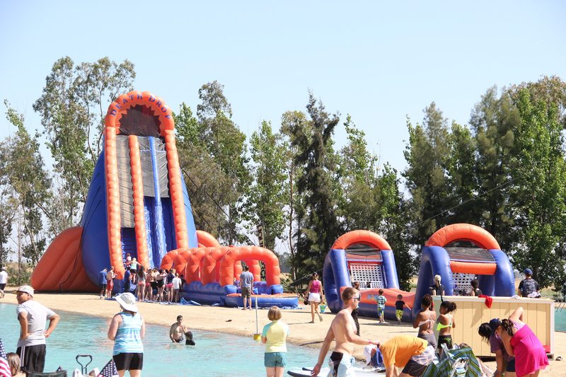 Giant water slide at a summer company picnic near a pool