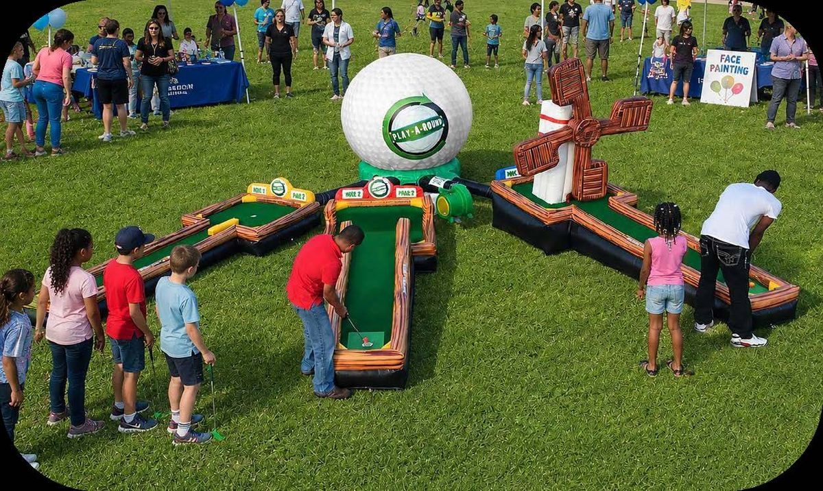 Kids playing a mini golf interactive game at a school field day
