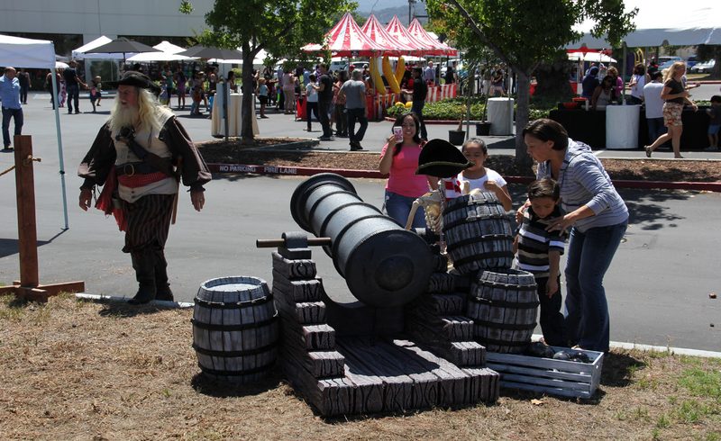 Pirate themed cannon prop and costumed actor at a themed company event