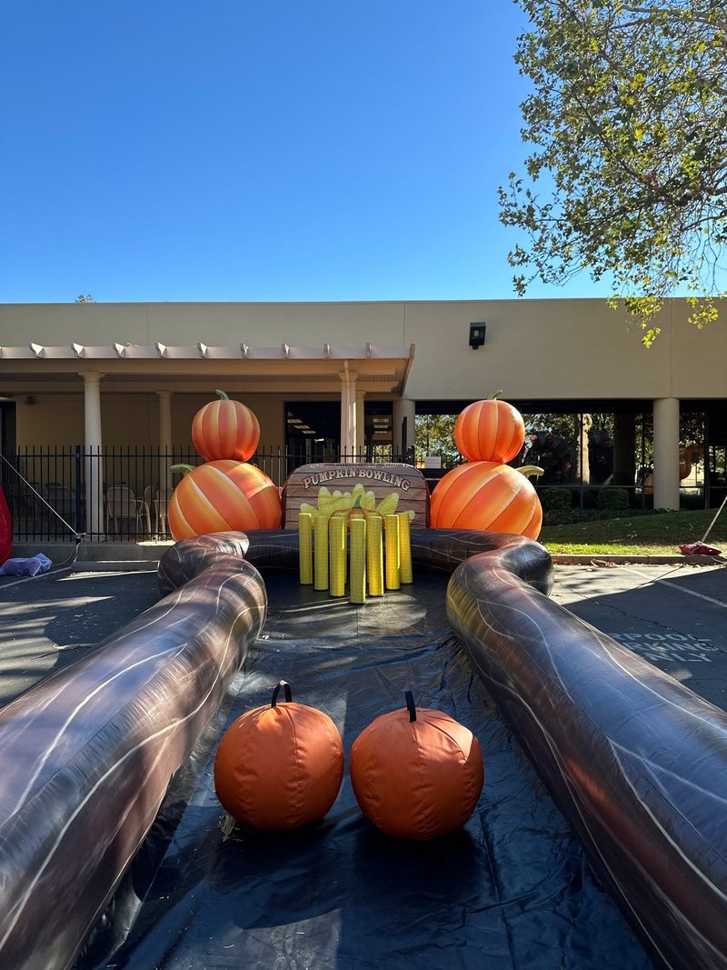 Pumpkin bowling lanes set up at a fall school carnival