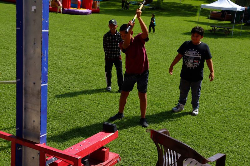 Kids playing a target toss game on the grass at a school field day