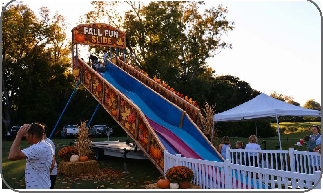Guests riding the Fall Fun Slide carnival ride at an outdoor Sacramento-area event