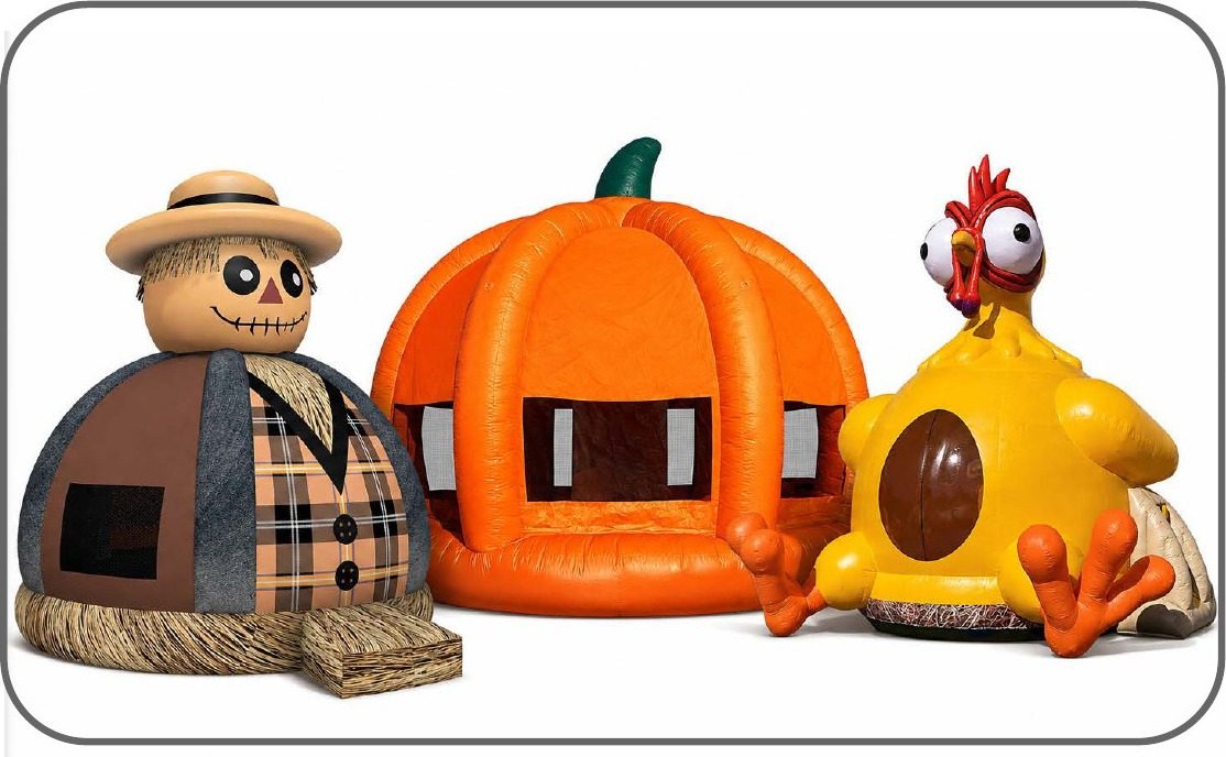 Fall themed inflatables including a scarecrow, pumpkin bounce house, and turkey