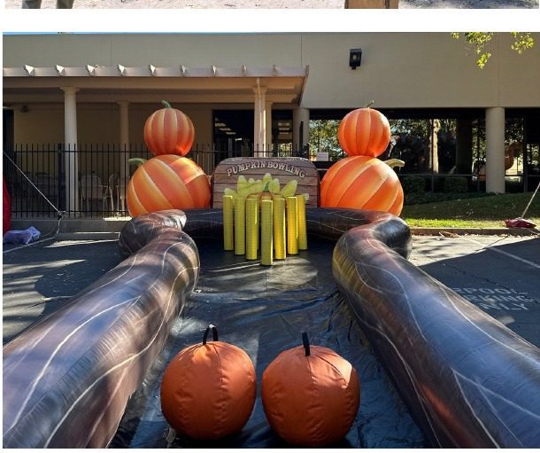 Pumpkin bowling lanes with pins set up at a fall festival
