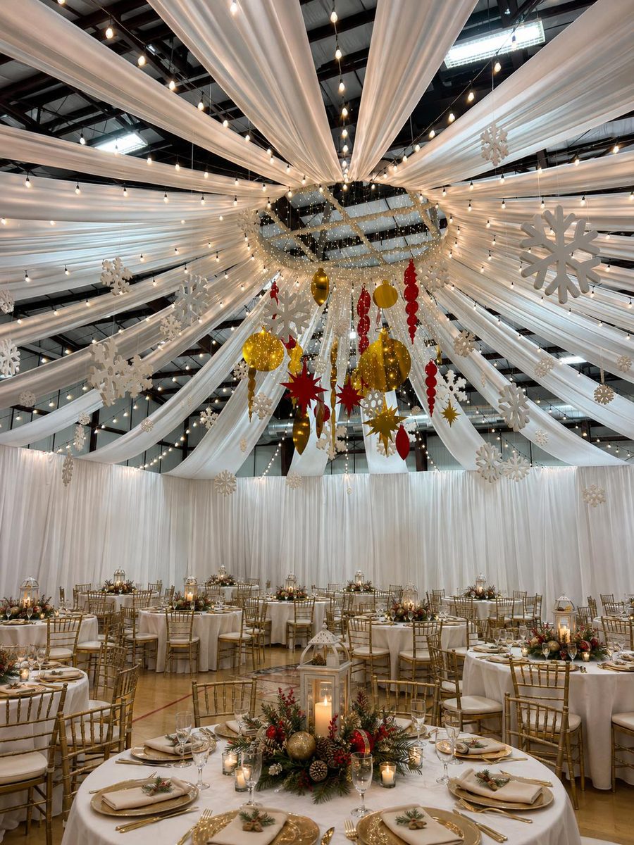 Decorated ballroom set for a Sacramento-area company Christmas party with draped ceiling and holiday centerpieces